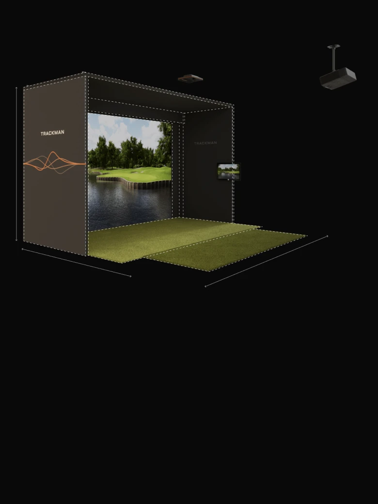 Golf simulator setup with a screen displaying a golf course, surrounded by black enclosures and a projector overhead, on a green mat.