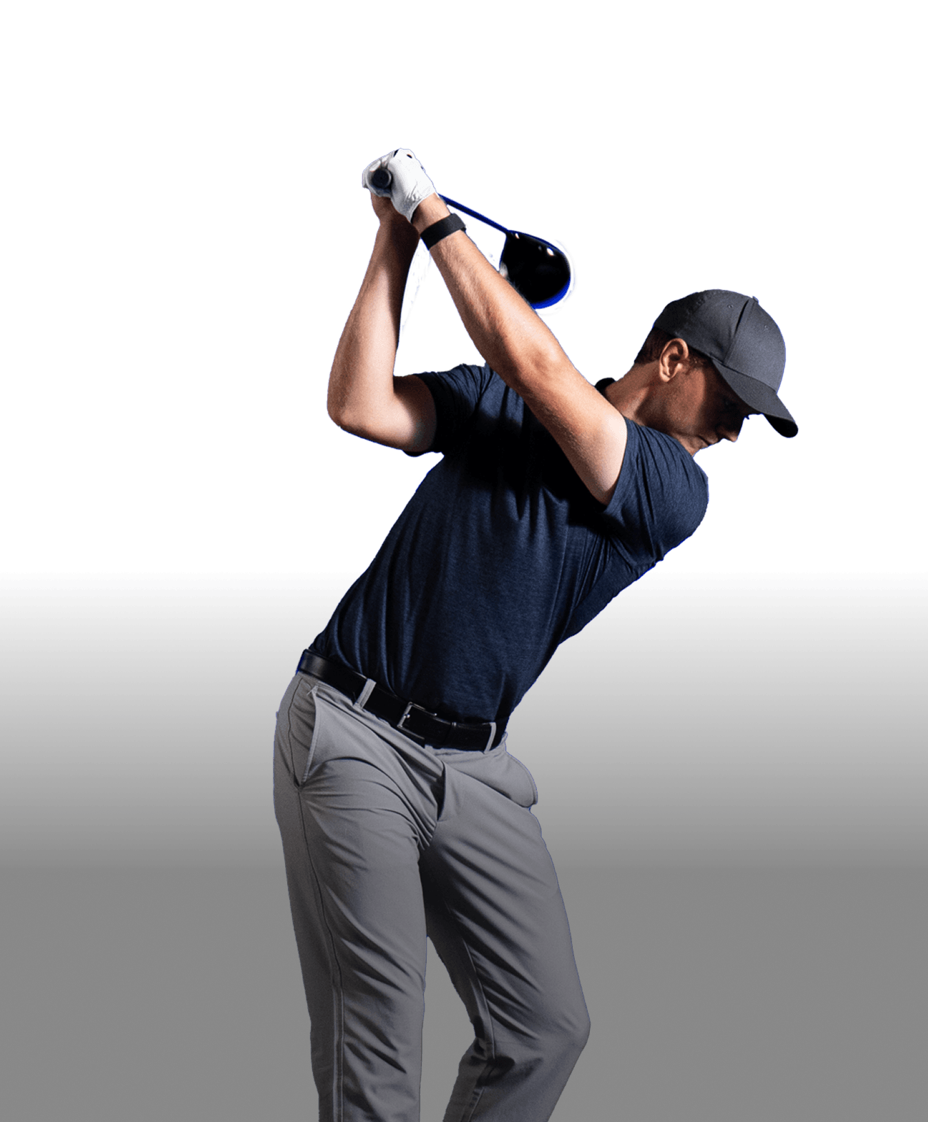 Golfer in a dark shirt and cap, mid-swing with a driver, against a dark background.